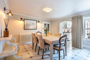 a dining room with a wooden table and chairs at The Belle - A lovingly converted Grade II Listed home from home in Bakewell in Bakewell