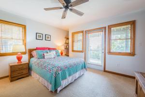 a bedroom with a bed and a ceiling fan at Sunset Royale in Duck