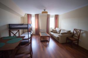 a living room with a couch and a bunk bed at Cabalo Furado Tui in Tui