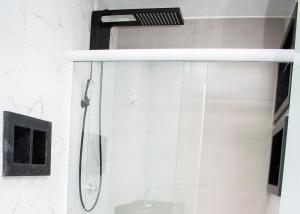 a shower with a glass door in a bathroom at Loft Rio Verde in Rio Verde +16 photos