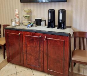 a counter with two coffee makers on top of it at Quality Inn Peterborough in Peterborough