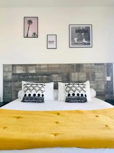 a bedroom with a large bed with two pillows at T2 Loft entre mer et montagne in Calenzana