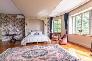 a bedroom with a bed and a rug at Château de Charmeil- Vichy chambres d'hôtes in Charmeil