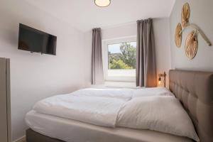 Postel nebo postele na pokoji v ubytování Haus Treibholz Apartment 7