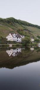 een huis naast een grote hoeveelheid water bij Doppelzimmer an der Lahn ohne Küche in Obernhof +7 foto's