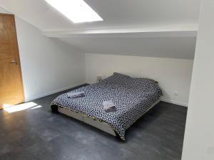 a bedroom with a bed in the corner of a room at La petite dame de Maintenon in Maintenon
