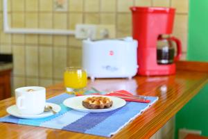 a table with a plate of food and a cup of orange juice at Palmasol Apartamentos in Puerto Rico de Gran Canaria