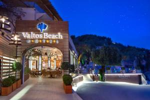 a building with a sign that reads valvlias beach at night at Valtos Beach Hotel in Parga