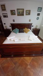 a large bed with white sheets and pillows on it at Appartamento in zona residenziale in Orosei