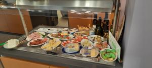 a buffet with many plates of food on a counter at Boutique hotel Lili in Rovinj