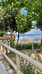 a fence with a view of the beach and the ocean at San Salvatore in Zakynthos Town