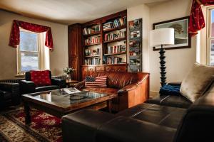 a living room with a leather couch and a coffee table at Galvanized America Inn & Art Gallery in Doylestown
