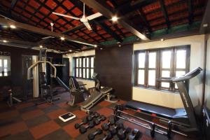 a gym with several treadmills and machines in a room at Konkan Crown Resort & Club in Sawantwadi