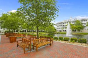 a row of benches in a park with a fountain at Sunset Island - 3 Canal Side Mews in Ocean City