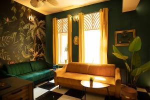a living room with a couch and a window at Jungle Apartments in Wrocław