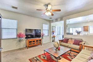 a living room with a couch and a ceiling fan at Sahuarita Retreat with Grill about 24 Mi to Tucson! in Green Valley