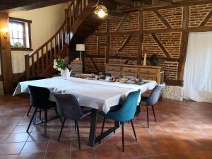 a table in a room with chairs around it at La ferme de la Terve in Bruailles
