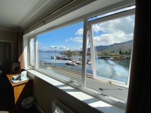 a window in a room with a view of a marina at White Heather Hotel in Kyleakin