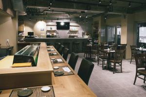 a dining room with tables and chairs and a bar at Henn na Hotel New York in New York