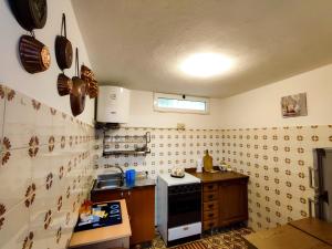a kitchen with a sink and a stove top oven at Casa vacanze Marinella in Santo Stefano al Mare