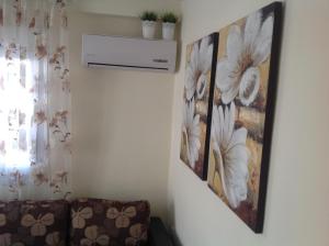 a room with two pictures of flowers on the wall at MyParalia apartament ***** in Paralia Katerinis