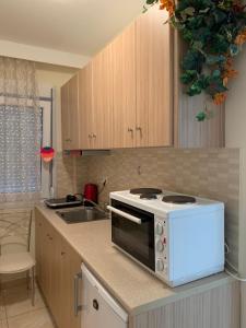 a kitchen with a microwave and a sink at MyParalia apartament ***** in Paralia Katerinis