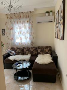 a living room with a couch and a table at MyParalia apartament ***** in Paralia Katerinis