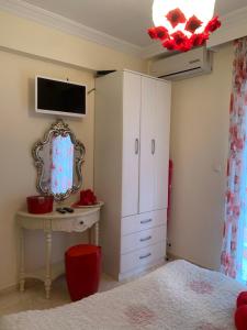 a bedroom with a bed and a dresser and a mirror at MyParalia apartament ***** in Paralia Katerinis