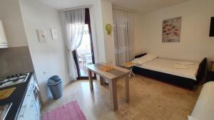 a small room with a bed and a table in it at Apartment Tonci in Novalja