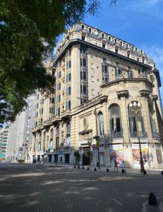 a large stone building on a city street at Florida garden in Buenos Aires