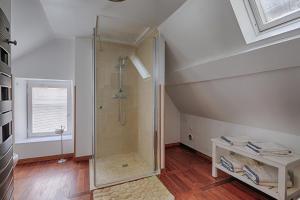 a bathroom with a shower in the attic at Maison de ville Bayeux in Bayeux