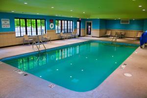 a large swimming pool with blue water in a building at Holiday Inn Express, an IHG Hotel in Douglas