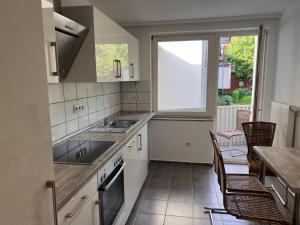 a kitchen with a sink and a table and chairs at Kassel Apartment am Entenanger in Kassel