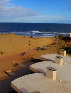 a view of a beach with the ocean at ARENAS DEL DIABLO in Punta Del Diablo