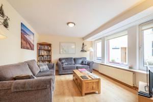 a living room with a couch and a table at Creel Cottage in Eyemouth