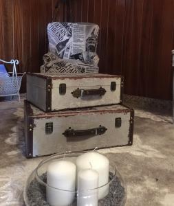 two old trunks with candles on a glass plate at HOTEL O NOSO BAR in Cambados