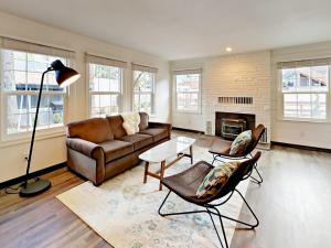 a living room with a couch and a fireplace at Manzanita Holiday 1 in South Lake Tahoe