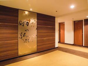 a room with a wall with wood paneling at Hotel Royal Morioka in Morioka +23 photos
