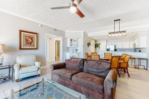 a living room with a couch and a dining room at Ocean's Edge 302 in Ocean City