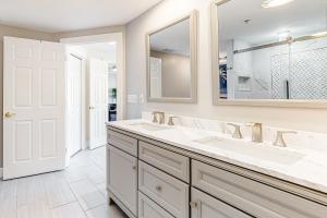 a bathroom with two sinks and a mirror at Ocean's Edge 302 in Ocean City