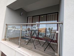 einen Balkon mit einem Tisch und 2 Stühlen darauf in der Unterkunft Silvaapartments in Praia da Barra