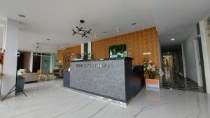 a lobby with a reception desk in a building at Rumah Familiku 1 Syariah in Wonocolo