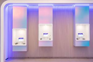 a bathroom with two urinals with purple and purple walls at YOTEL Miami in Miami
