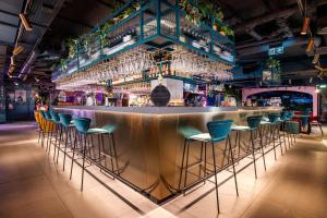 a bar with chairs and wine glasses at YOTEL Manchester Deansgate in Manchester +96 photos