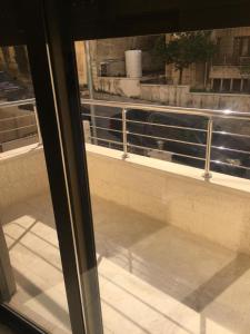 a view of a window with a view of a building at New and cosy apartment in Amman (Al Weibdeh) in Amman
