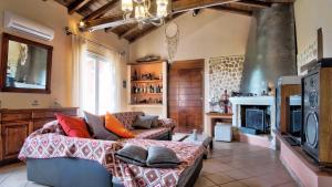 a living room with a couch and a fireplace at Kornata Country House in Kornáta