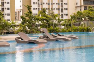 a row of sandals sitting on the side of a swimming pool at Noble Cebu Hotel in Cebu City