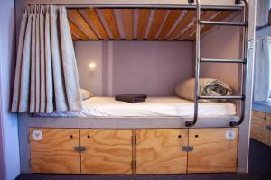 a bunk bed room with a bunk bed on top at Absoloot Hostel Queenstown in Queenstown
