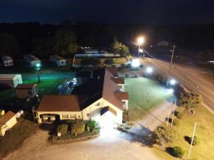 an overhead view of a house at night with lights at Four Oaks Lodging in Smithfield