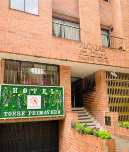 a brick building with a sign on the front of it at Hotel Torre Primavera in Medellín
